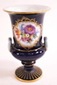 A 20th century Meissen style porcelain two handled urn, painted with coloured enamels with flowers,