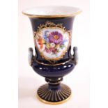 A 20th century Meissen style porcelain two handled urn, painted with coloured enamels with flowers,