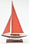 A Nauticalia wooden model pond yacht on stand,