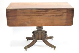 A 19th century mahogany Pembroke table with turned pedestal on four splayed legs,