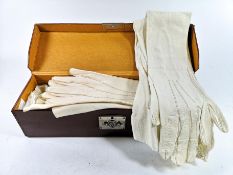 A leather box containing two pairs of kid elbow length evening gloves and others