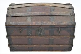 A domed trunk with two handles, the top opening to reveal a paper lined interior, 57cm high,