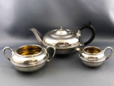 A silver three piece tea set,