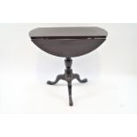 A mahogany tripod table with drop leaves,