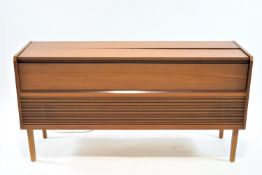 A teak cased HMV radiogram with three speed drop turntable, 67cm high, 132cm wide,