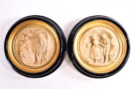 A pair of resin plaques of tondo of rondel form with cameo scenes of lovers in rural landscapes,