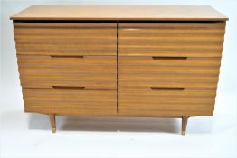 A mid 20th century standing six drawer side cabinet on tapering legs, 82cm high, 125cm wide,