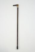 A pair of walking sticks with silver bands, in carved hardwood with horn handles,