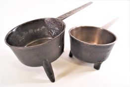 An eighteenth century bronze skillet or posnet, raised on three legs, the handle marked Wasbrough,