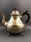 A silver bachelor teapot of baluster form, set a domed, fluted lid over a similarly decorated body,