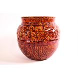 A Burmantoft Faience ginger jar style planter decorated in red,