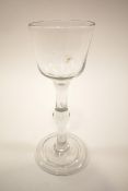 A 19th century drinking glass with baluster stem on folded foot,