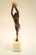 An Art Deco style bronze figure of a lady in athletic pose with ball on marble plinth,