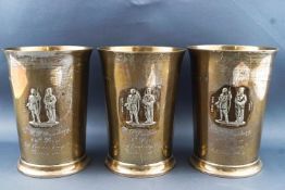 A set of three silver beakers, each of plain slightly flared trumpet form,
