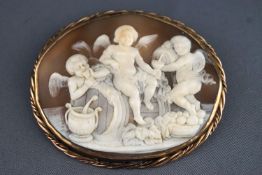 A large carved shell cameo brooch measuring 60.0mm x 50.0mm within a unhallmarked rope edge mounted.