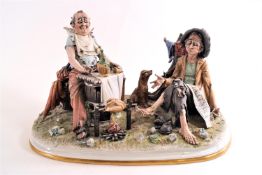 A Capodimonte figure, 'The Dolce Vita', showing two hobos roasting a chicken over a wood fire,
