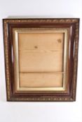 A Victorian painted wood effect picture frame with inner fillet and two bands of gilded moulding,