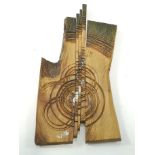 A 20th century carved and painted wall hanging with abstract design,