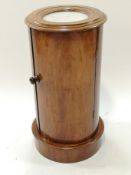 A Victorian mahogany cylindrical pot cupboard, with inset m,arble top and plinth base,