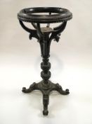 An Anglo Indian hardwood washstand, (? Evans), the single turned pedestal on four scrolled supports,