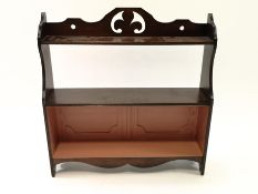 A 19th century mahogany three tier hanging wall shelf with painted back,