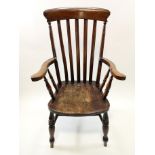 A 19th century Windsor chair of traditional form, with shaped elm seat supporting the arms,