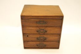 An early 20th century mahogany small table top chest of drawers,