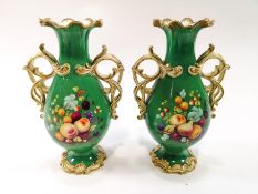 A pair of 19th century porcelain vases, each with entwined handles,