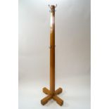 A mahogany coat rack of square tapering form on X base,