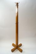 A mahogany coat rack of square tapering form on X base,