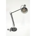 A black anglepoise lamp,