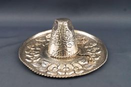 A white metal Mexican sombrero model hat, with repousse decoration, marked Sterling Mexico,