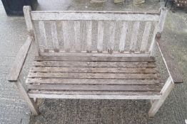 A wooden garden bench (cushion in reception),
