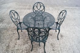 A green aluminium garden set of a table and four chairs