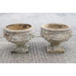 A pair of composit round garden urns,