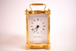 A carriage clock in gilt four glass case, the dial marked Fox & Simpson,