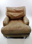 A leather armchair with loose cushion, back and seat,