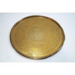 A Middle Eastern brass tray, of round form, with typical decoration,