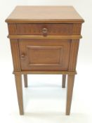A Continental oak pot cupboard with one frieze drawer above a panelled door on square tapering legs