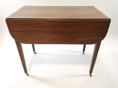 A 19th century mahogany Pembroke table on square tapering legs,