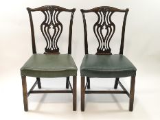 A pair of George III style mahogany dining chairs with carved and pierced splats,