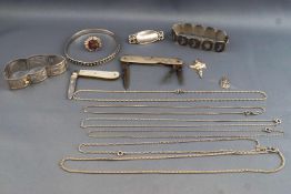 A collection of items to include two silver panel bracelets, a silver oxidized bangle,