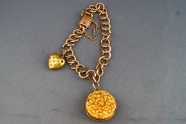 A yellow metal curb link bracelet with push in clasp and safety chain