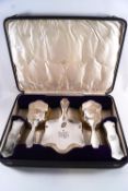 A cased five piece silver dressing table set of plain shaped fiddle form, comprising a hand mirror,