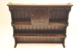 A late Victorian oak plated dresser back with central cupboard,