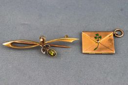 A yellow metal bar brooch of floral design set with peridot and seed pearl.