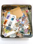 A tin of World and GB/Commonwealth stamps (loose,