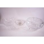 A round cut glass bowl on three feet, another bowl and two ash trays,