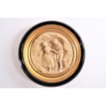 A pair of resin plaques of tondo and rondel form with cameo scenes of lovers in rural landscapes,