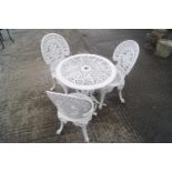 A white 1970's patio set with three chairs